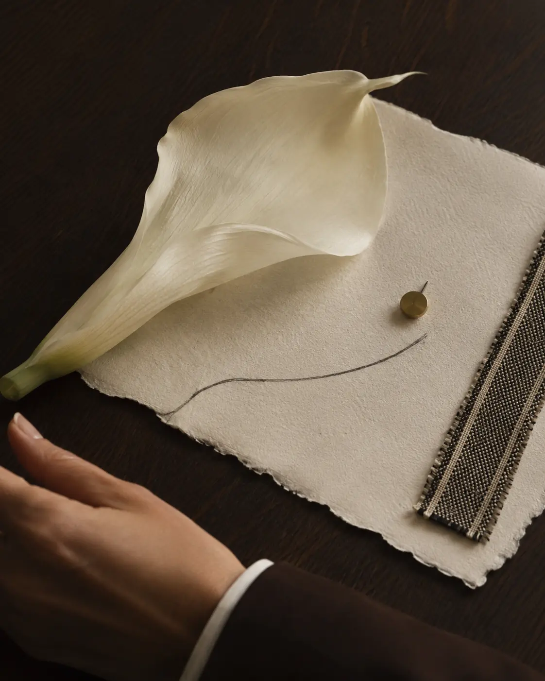 Tactile editorial arrangement of paper, fabric and sculptural materials